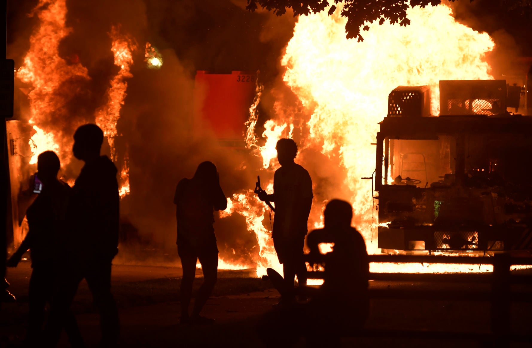 Garbage and dump trucks were set ablaze on Sunday, Aug. 23, 2020 by rioters near the Kenosha County Courthouse where they had been set up to prevent damage to the building.