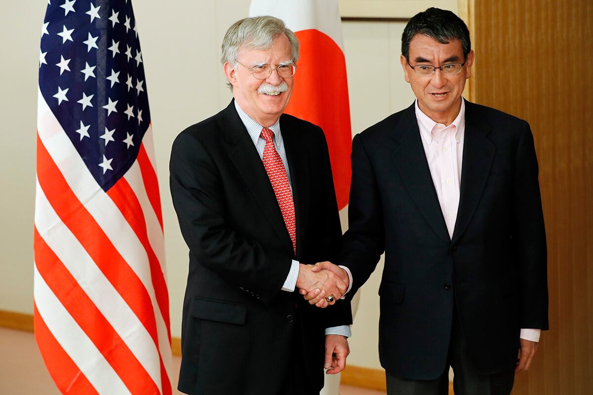 Japanese Foreign Minister Taro Kono, right, and U.S. National Security Advisor John Bolton, left, shake hands prior to their meeting in Tokyo Monday, July 22, 2019.