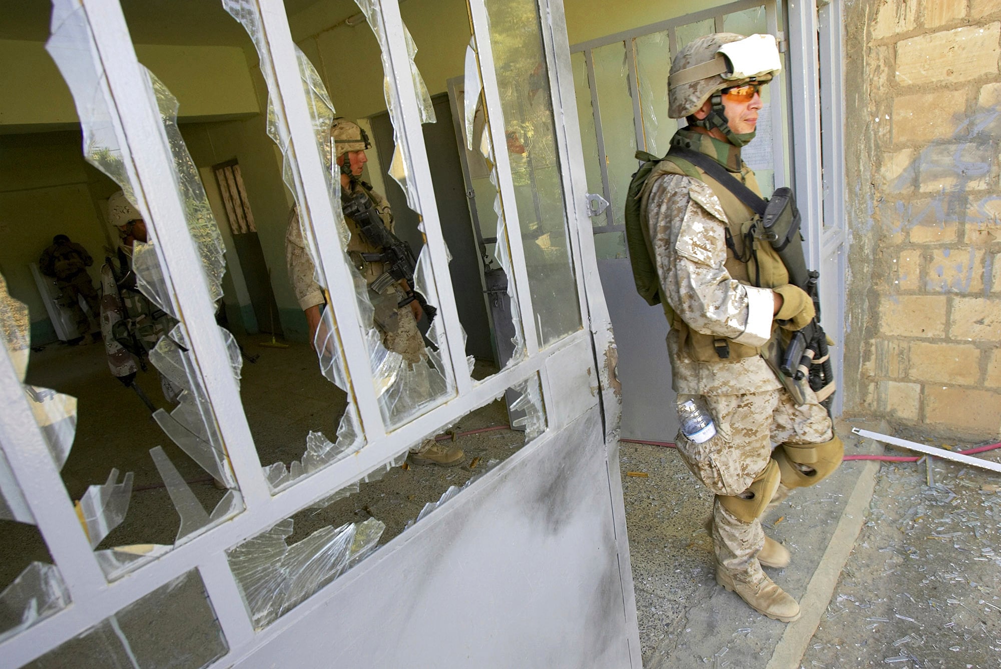 This file photo from Aug. 6, 2005, shows U.S. Marine Staff Sgt. Brian Hamilton of Columbus, Ohio, from Lima Company of the 3rd Battalion, 25th Regiment as he exits after searching a school, in Parwana, near Haditha, Iraq.