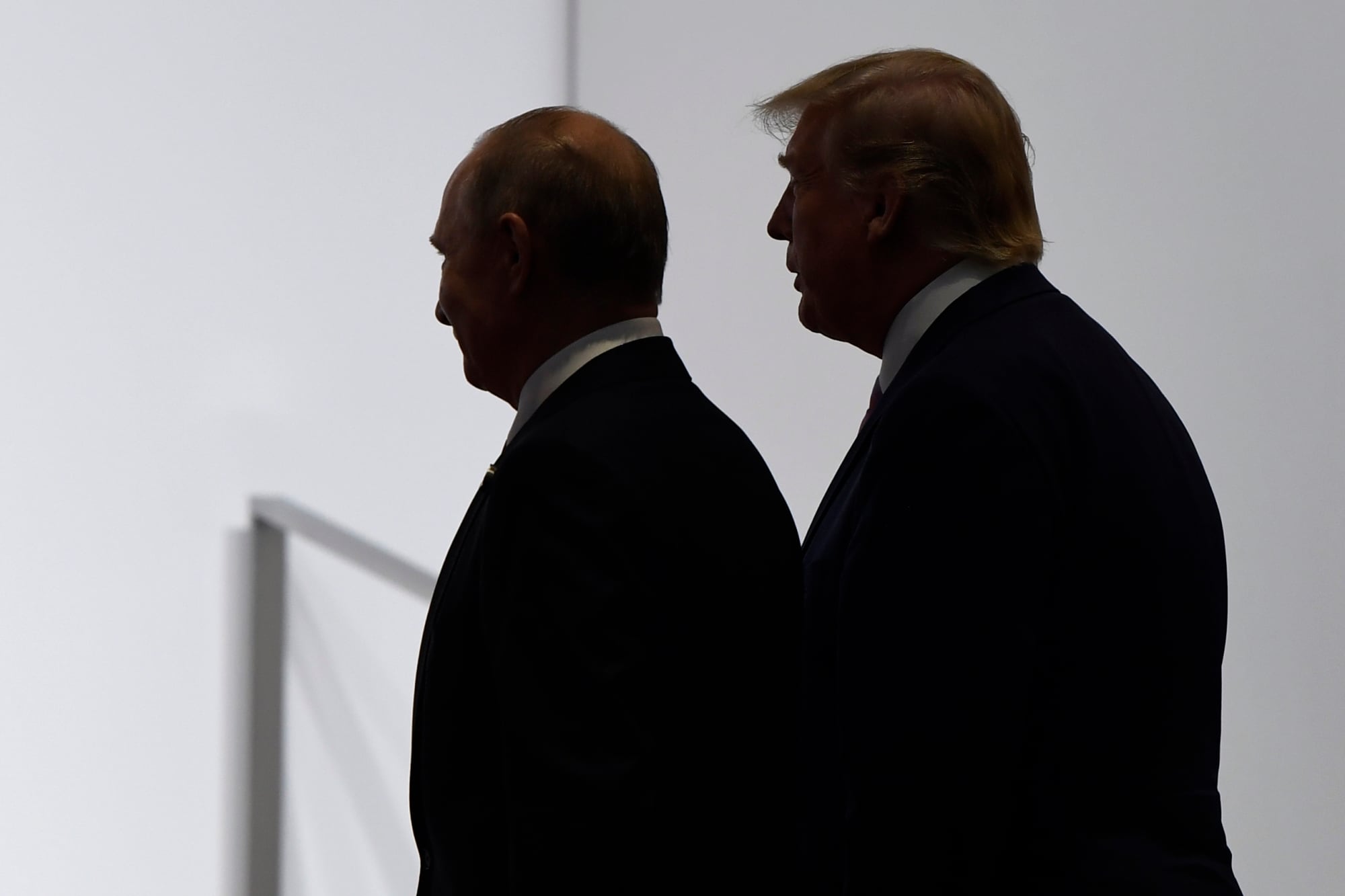 In this June 28, 2019, file photo, President Donald Trump and Russian President Vladimir Putin walk to participate in a group photo at the G20 summit in Osaka, Japan.