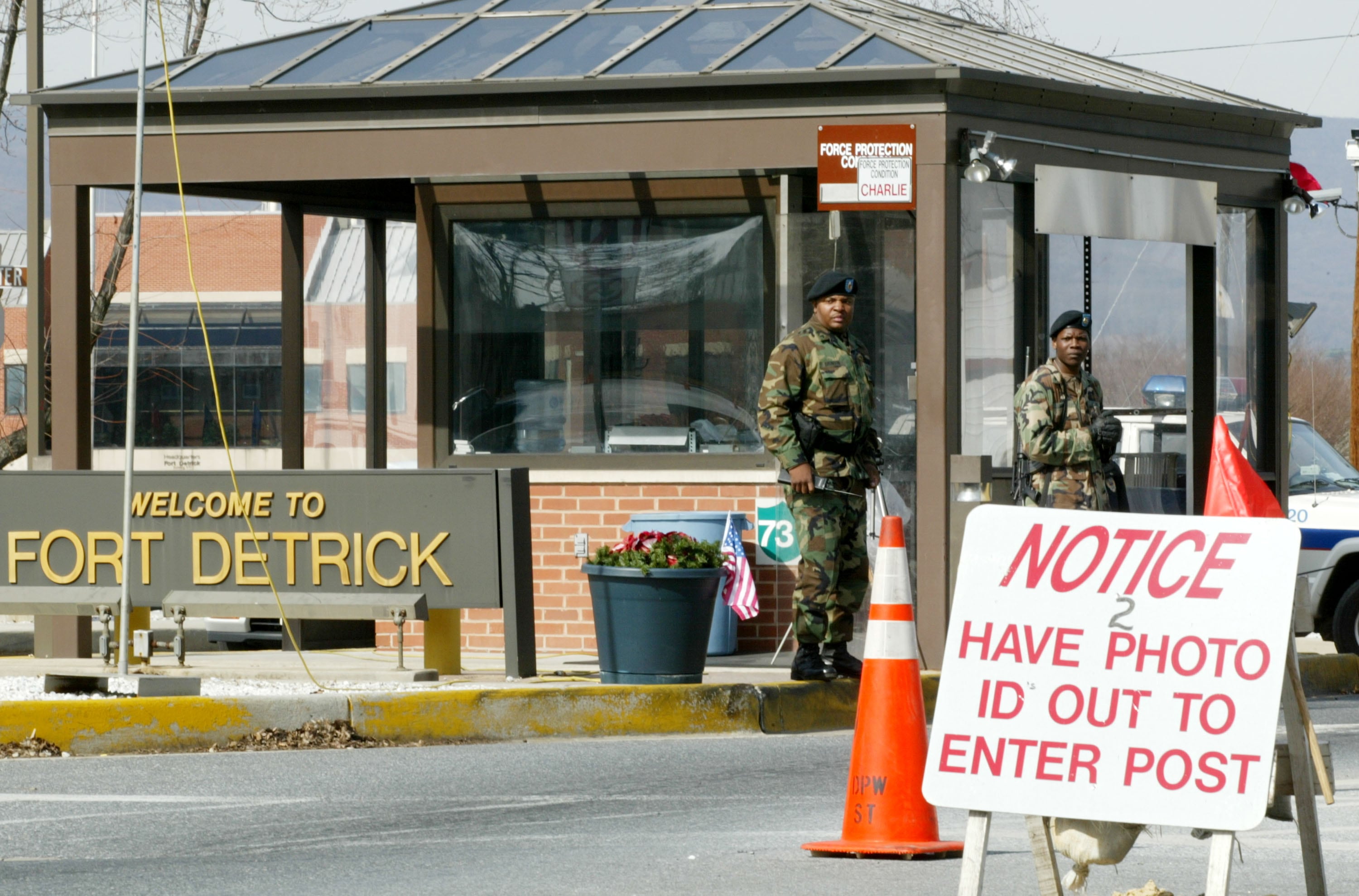 Two soldiers stand guard February 25, 2002 at the main gate of Fort Detrick in Frederick, Maryland, where the U.S. Army Medical Research Institute of Infections Diseases is located.