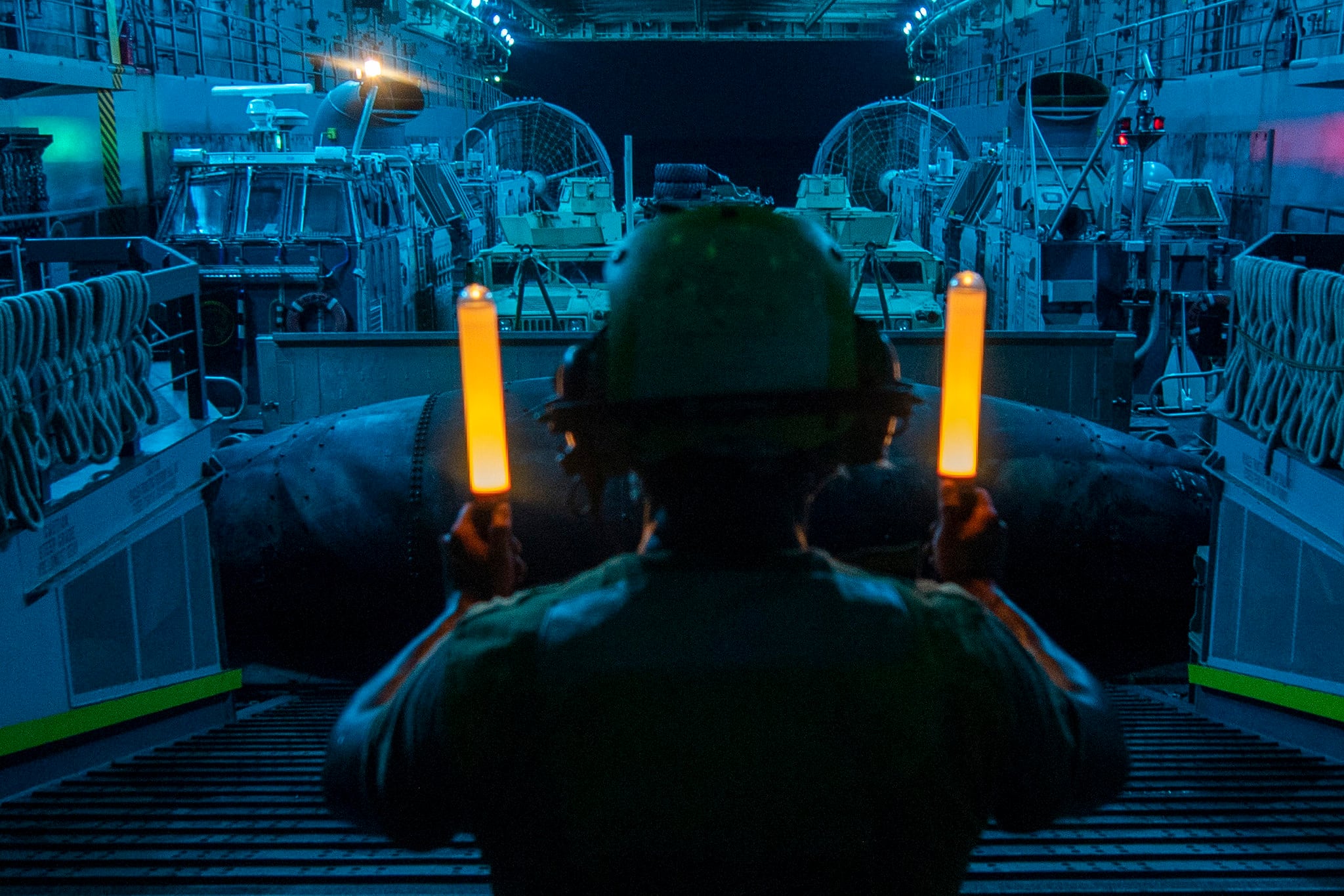 Seaman Juan Rivera signals a landing craft, air cushion Aug. 23, 2019, during well deck operations aboard the amphibious transport dock ship USS John P. Murtha (LPD 26) in the Red Sea.