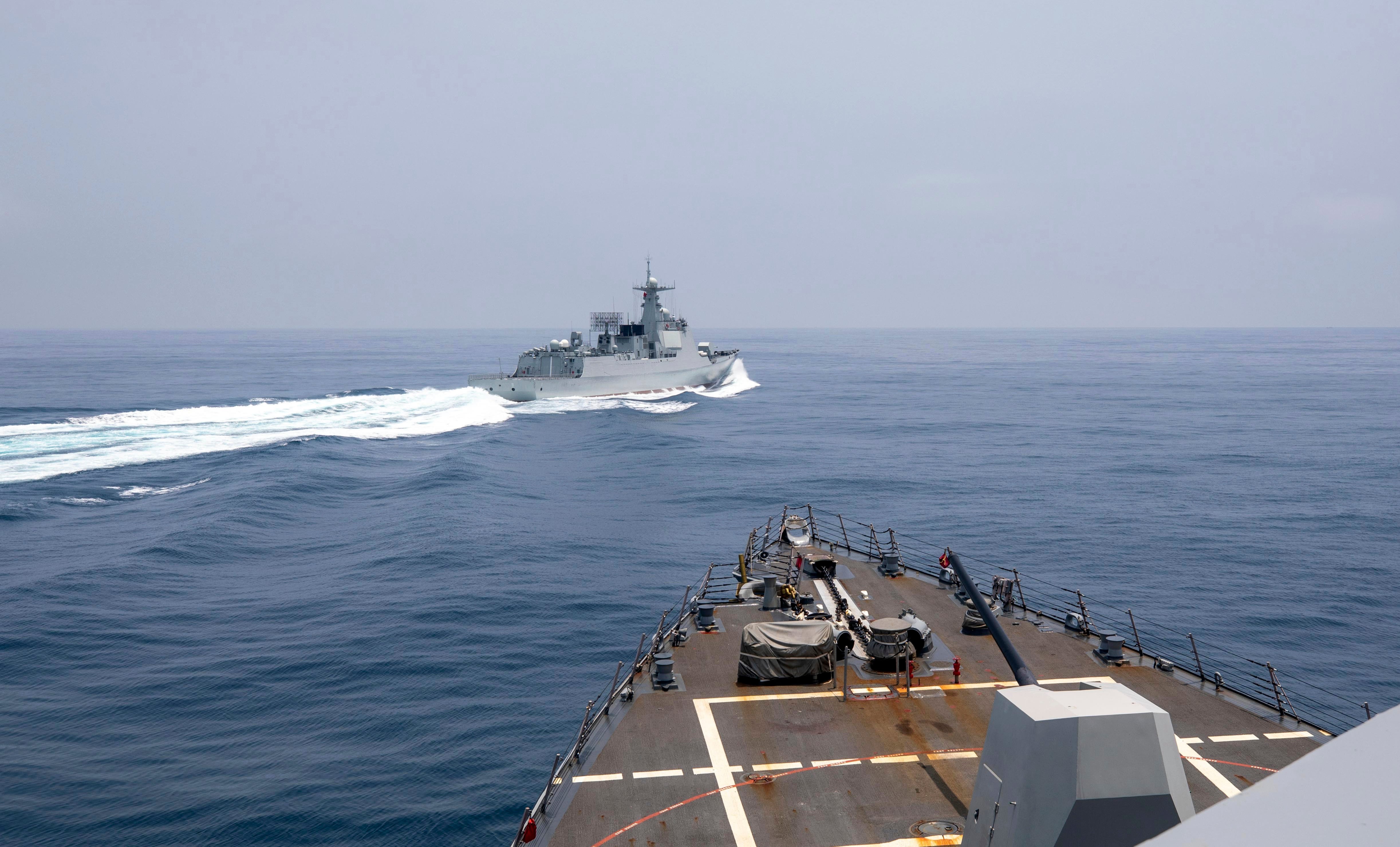 In this photo provided by the U.S. Navy, the guided-missile destroyer Chung-Hoon observes a Chinese navy ship conduct what it called an "unsafe” Chinese maneuver in the Taiwan Strait, Saturday, June 3, 2023.