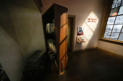 A bookcase revealing a secret hiding place is part of a replica of the home in Amsterdam where Anne Frank hid, in the new pavilion opening at the National World War II Museum in New Orleans, Tuesday, Oct. 31, 2023.