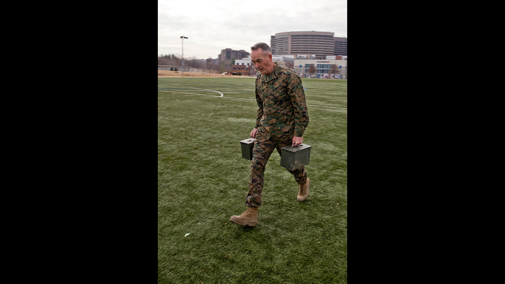 Then-Commandant of the Marine Corps Gen. Joseph Dunford Jr. transports two 30-pound ammunition cans during his Combat Fitness Test in Washington on Dec. 15, 2014.