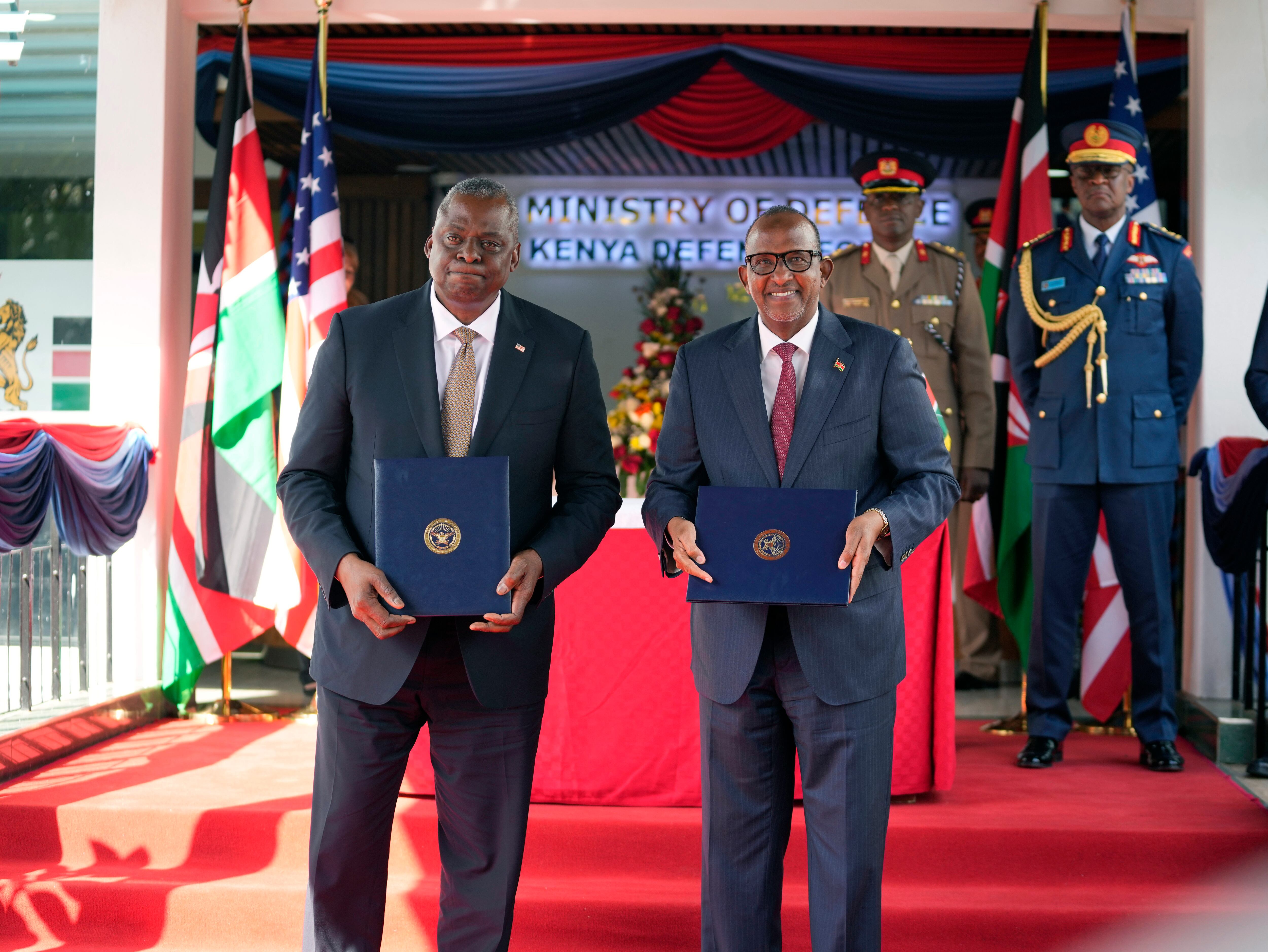 U.S. Secretary of Defense Lloyd J. Austin, left and Kenya Cabinet Secretary for Defense Aden Duale, hold copies of a signed bilateral defense cooperation agreement, in Nairobi, Kenya, Monday Sept. 25, 2023.