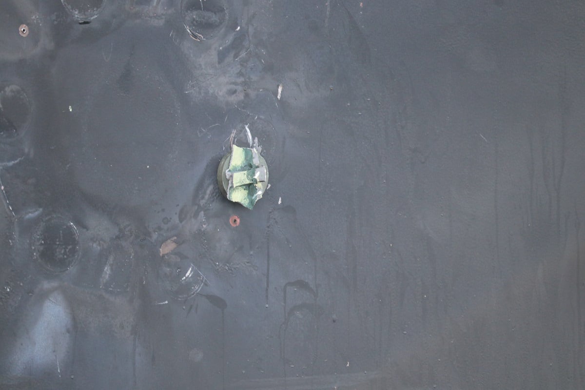 This is the view of the remnants of a removed limpet mine’s placement, location, and damage sustained from a limpet mine attack, on the starboard side of motor vessel M/T Kokuka Courageous, while operating in the Gulf of Oman, June 13. A limpet mine is attached to a vessel via magnet and/or nails. The holes seen were created by nails used to hold the mine in place. (CENTCOM)