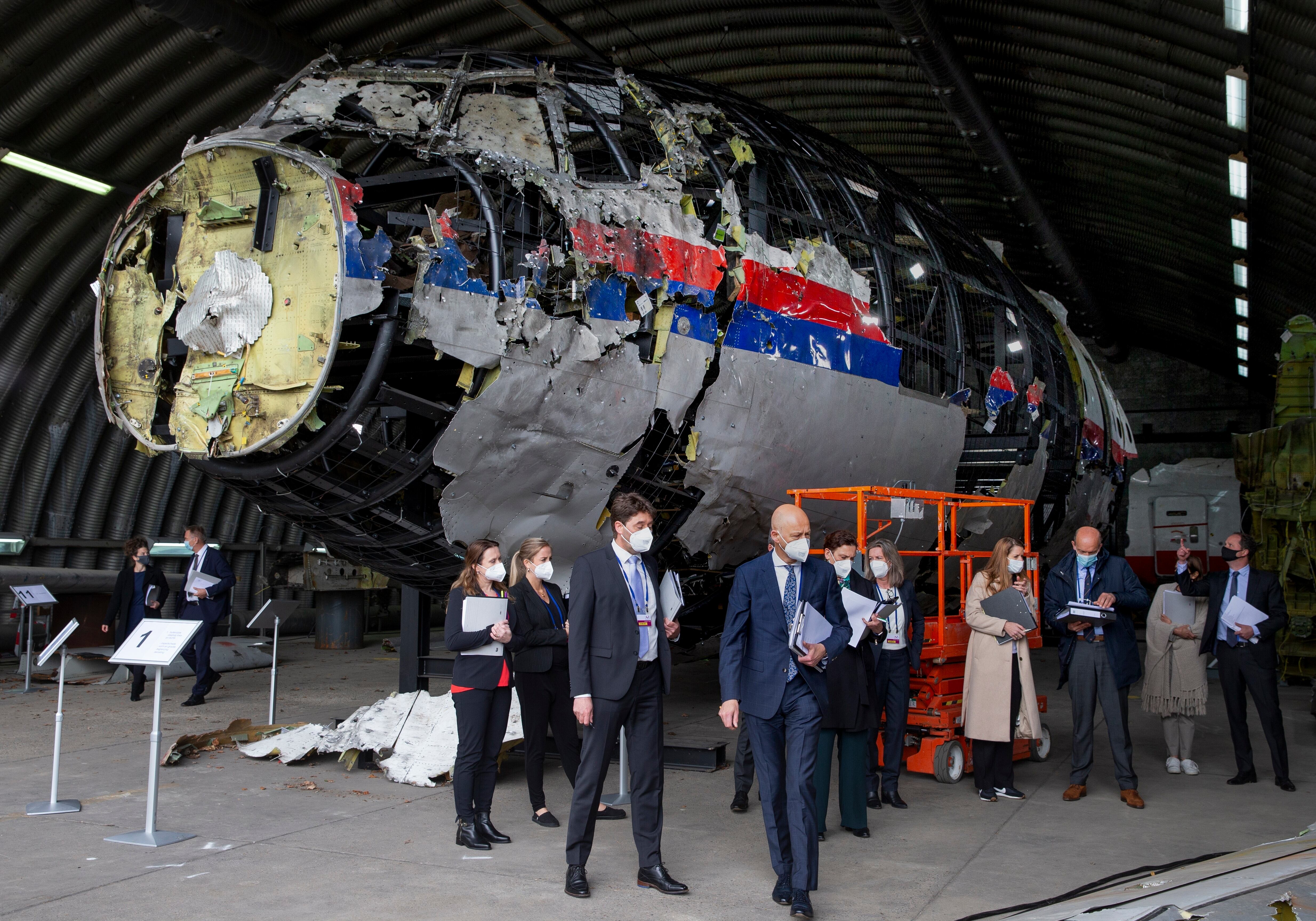 Judges and lawyers view the reconstructed wreckage of Malaysia Airlines Flight MH17, at the Gilze-Rijen military Airbase, southern Netherlands, on May 26, 2021.