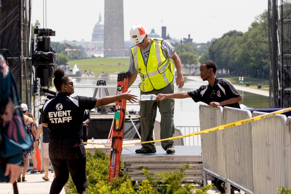 The Capitol Dome, the Washington Monument and the Reflecting Pool are visible as workers set up for President Donald Trump's "Salute to America" event honoring service branches on Independence Day at the Lincoln Memorial, Tuesday, July 2, 2019, in Washington.