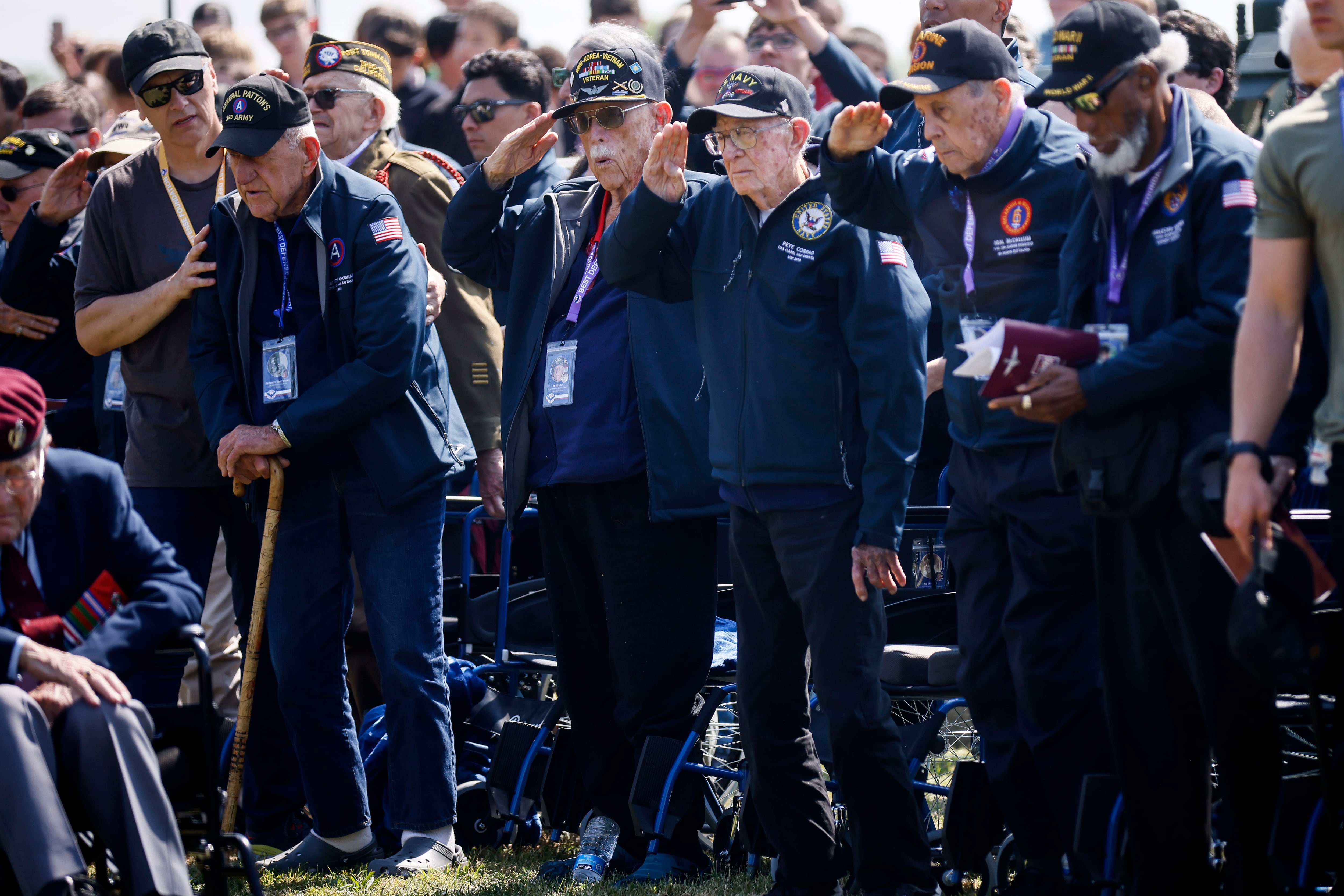 U.S war veterans salute during a ceremony outside the Pegasus Bridge memorial in Benouville, Normandy, Monday, June 5, 2023.