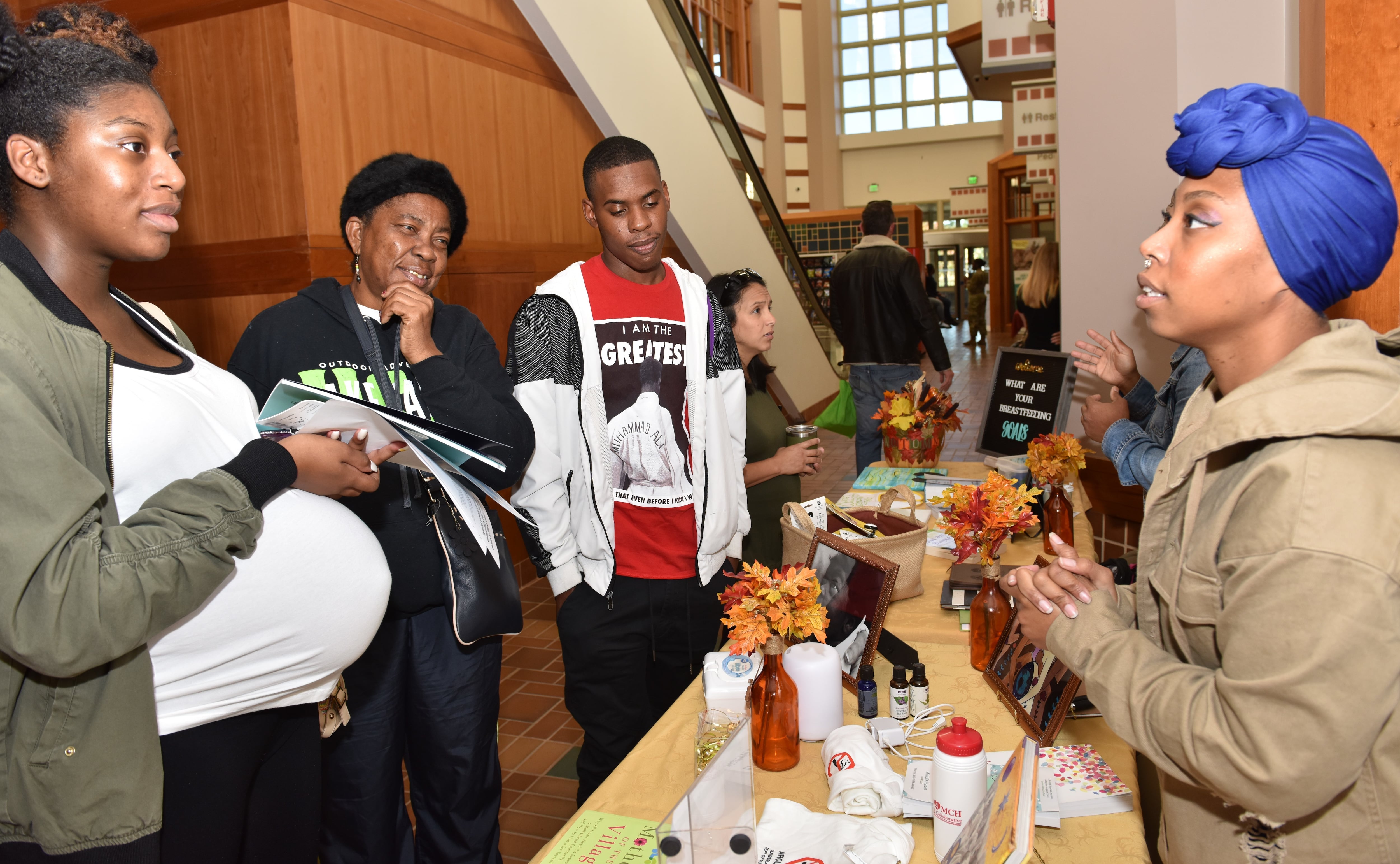 Dominique Hunter, the Military Breastfeeding Network active duty director, explains doula and breastfeeding options to new moms at a Womack Army Medical Center maternity fair at Fort Liberty, North Carolina, in 2018.