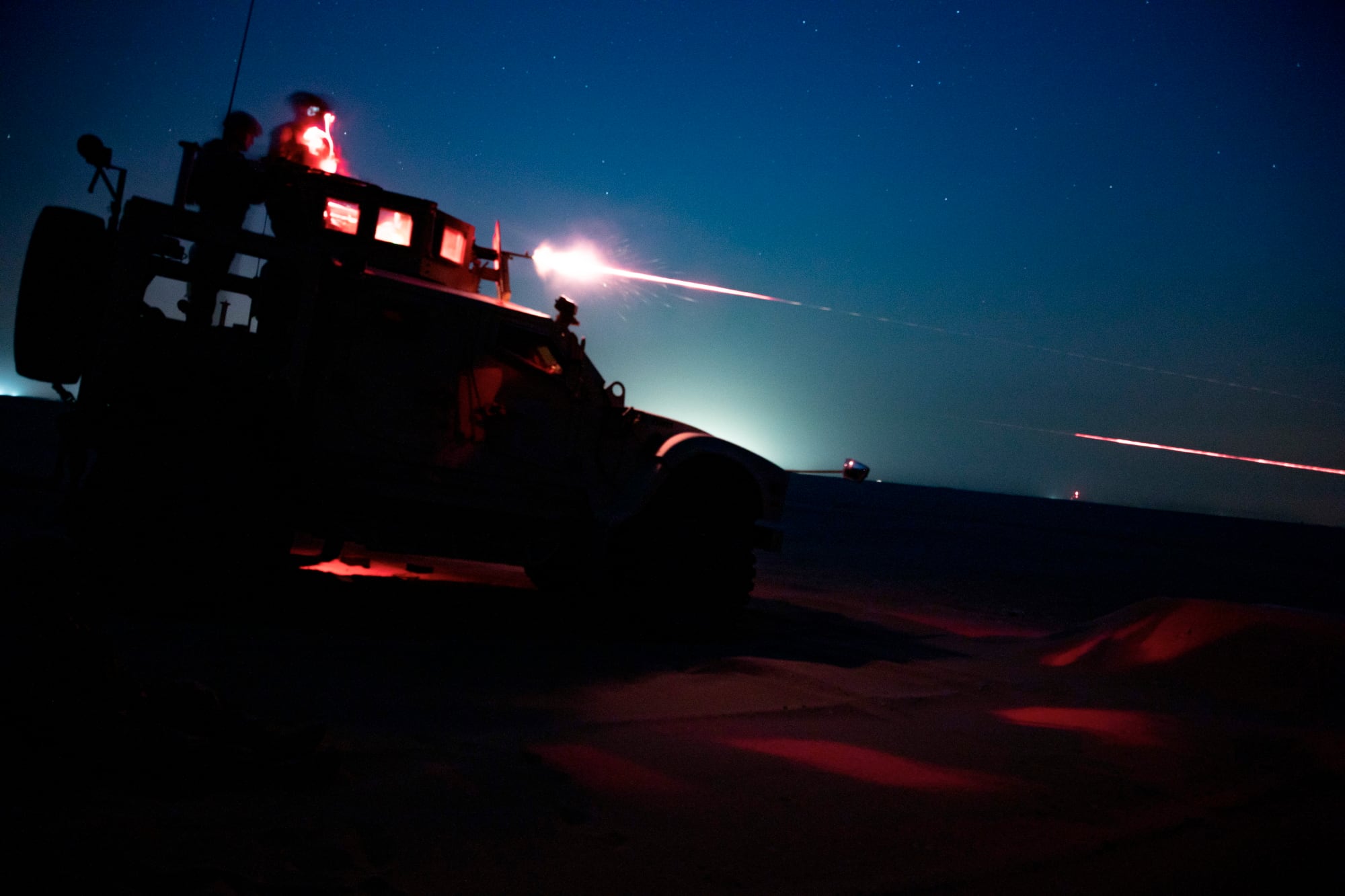 U.S. Marines fire an M240B from an MRAP All-Terrain Vehicle during night time machinegun range in Kuwait, June 16, 2020.