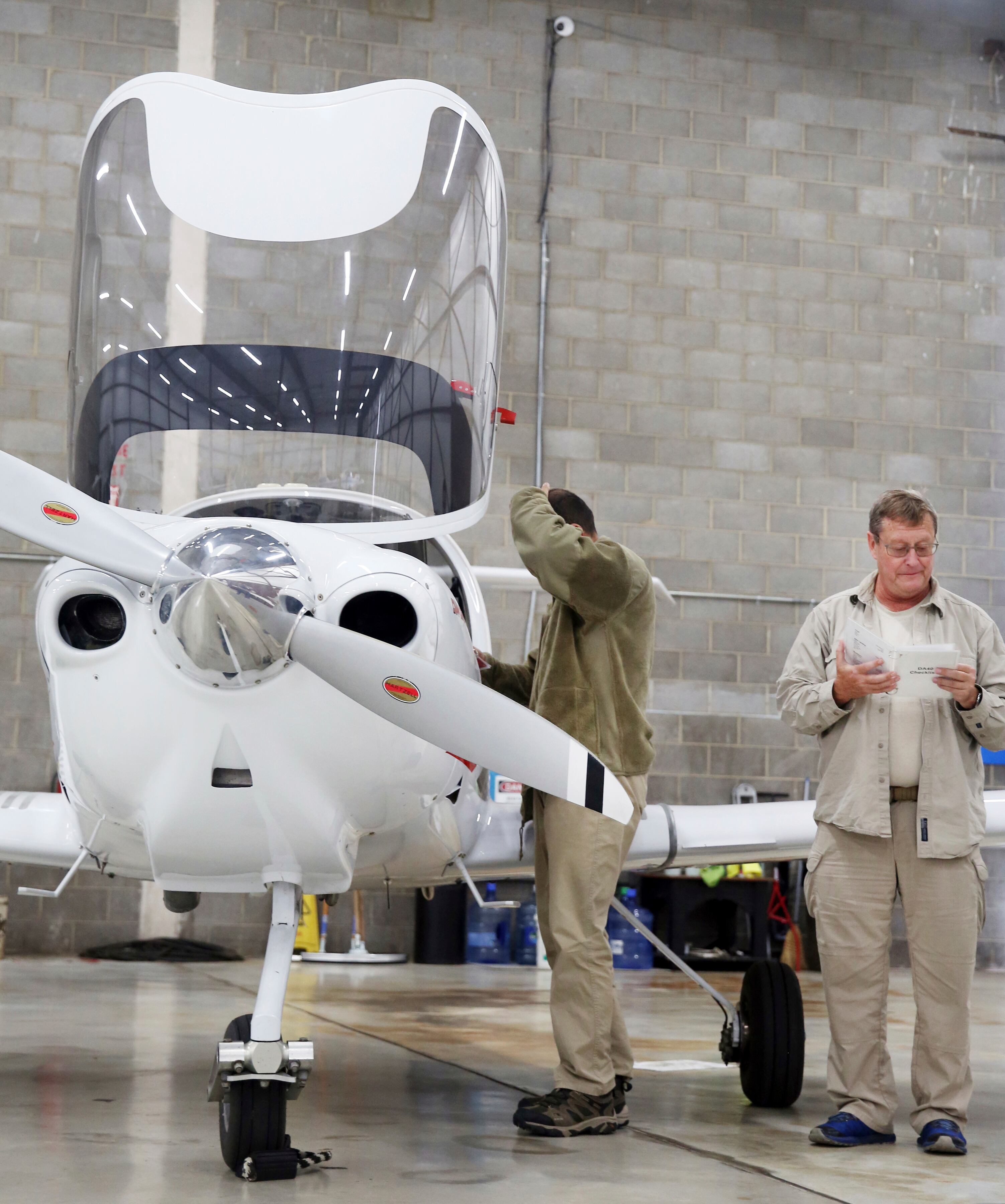 Tashmorad Qara, left, and Orin Osmon, a retired U.S. Air Force pilot who was Qara's flight instructor in Afghanistan, tour airplanes at Star Flight Training, a flight school located at Roanoke-Blacksburg Regional Airport in Roanoke, Va.