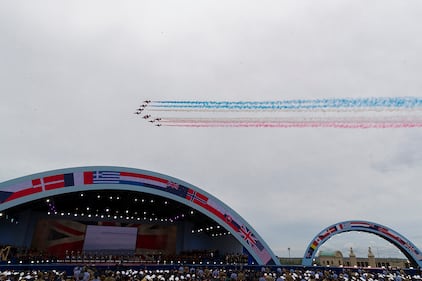 A flyover trails colored smoke to conclude a ceremony to mark the 75th Anniversary of D-Day