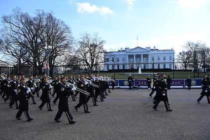 A military band parades on the street near the White House after President Joe Biden and Vice President Kamala Harris were sworn in at the Capitol on Jan. 20, 2021, in Washington.