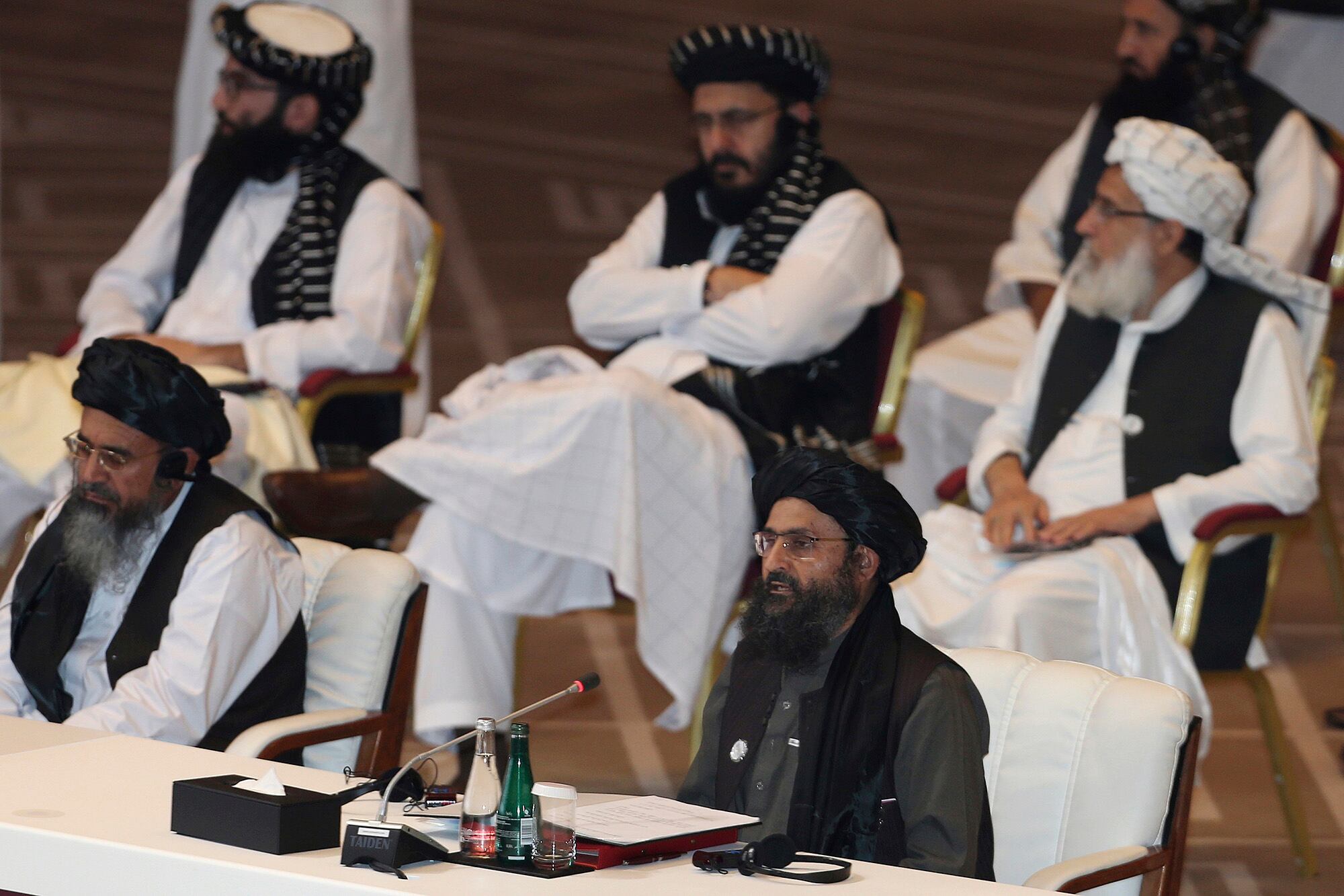 In this Sept. 12, 2020, file photo, Taliban co-founder Mullah Abdul Ghani Baradar, bottom right, speaks at the opening session of peace talks between the Afghan government and the Taliban in Doha, Qatar.