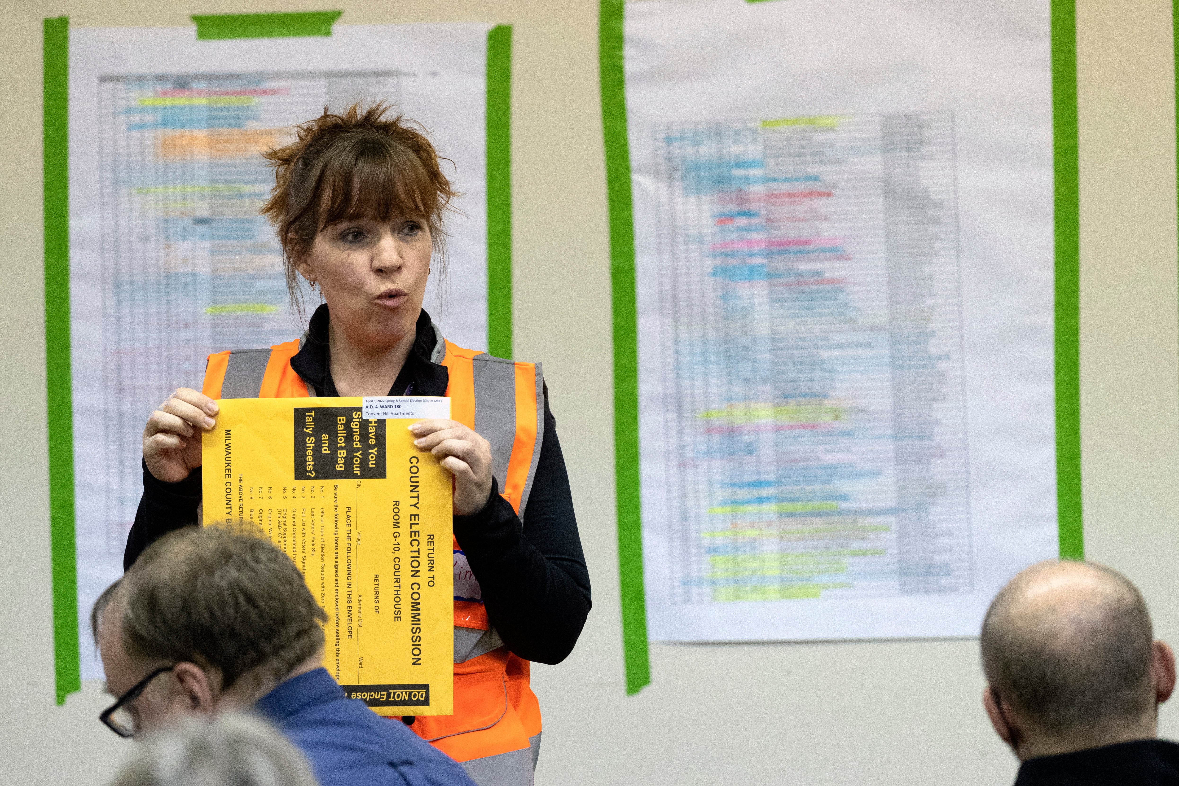 Kimberly Zapata, deputy director of the Milwaukee Election Commission, instructs workers processing ballots, Tuesday, April 5, 2022, at the central counting facility in Milwaukee, Wis.