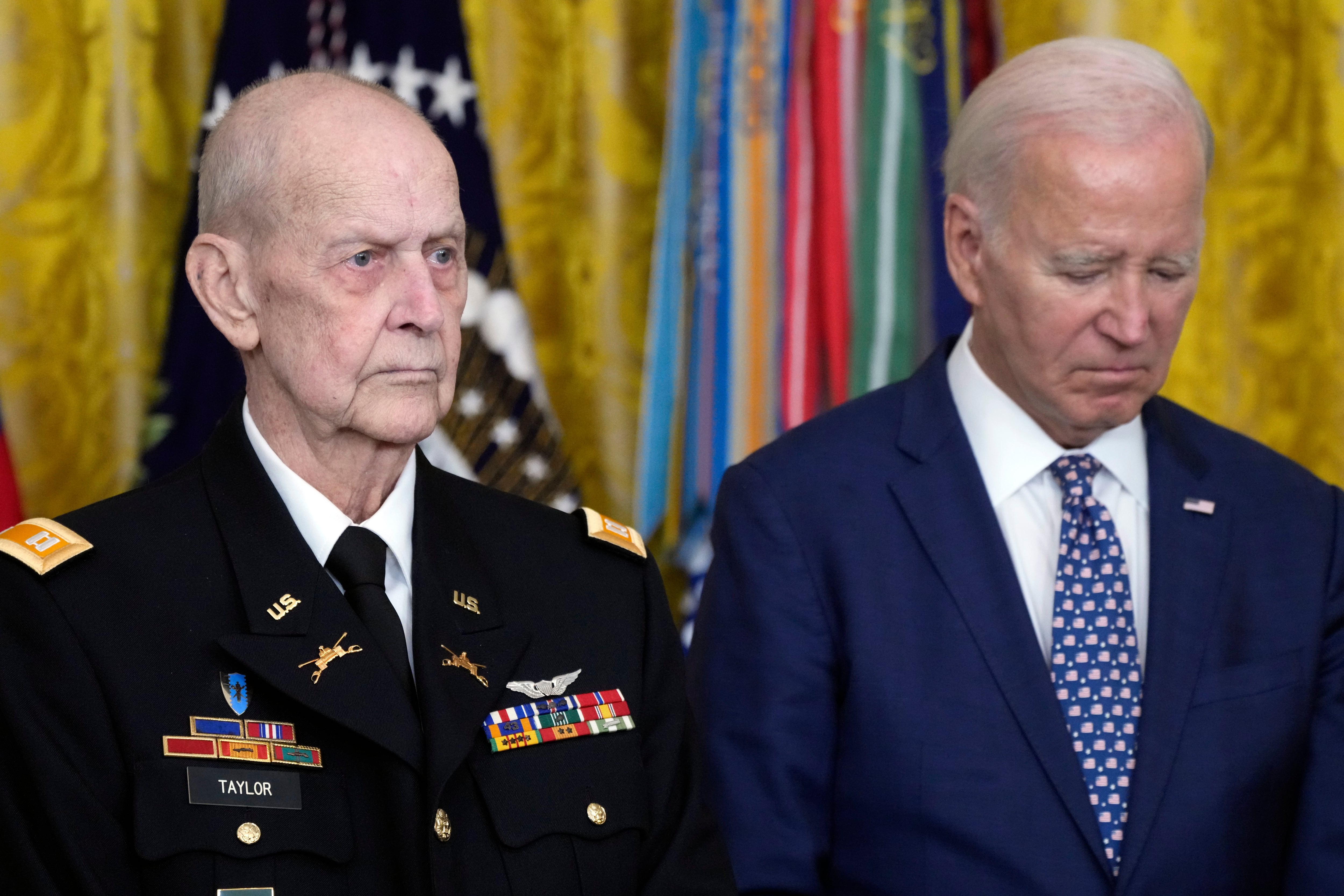 President Joe Biden listens to the citation being read before he awards the Medal of Honor to Capt. Larry Taylor, an Army pilot from the Vietnam War who risked his life to rescue a reconnaissance team that was about to be overrun by the enemy, during a ceremony Tuesday, Sept. 5, 2023, in the East Room of the White House in Washington.