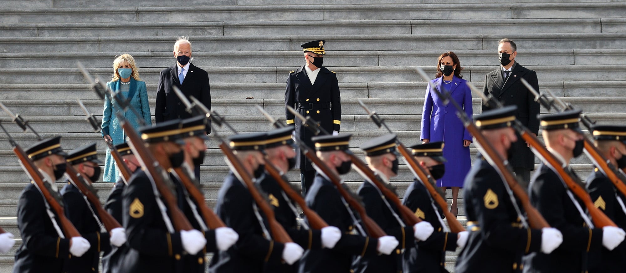 From left to right: first lady Dr. Jill Biden, President Joe Biden, Vice President Kamala Harris, and Doug Emhoffl, Harris' husband, watch a military pass-in-review during the inauguration on the West Front of the Capitol on January 20, 2021 in Washington.