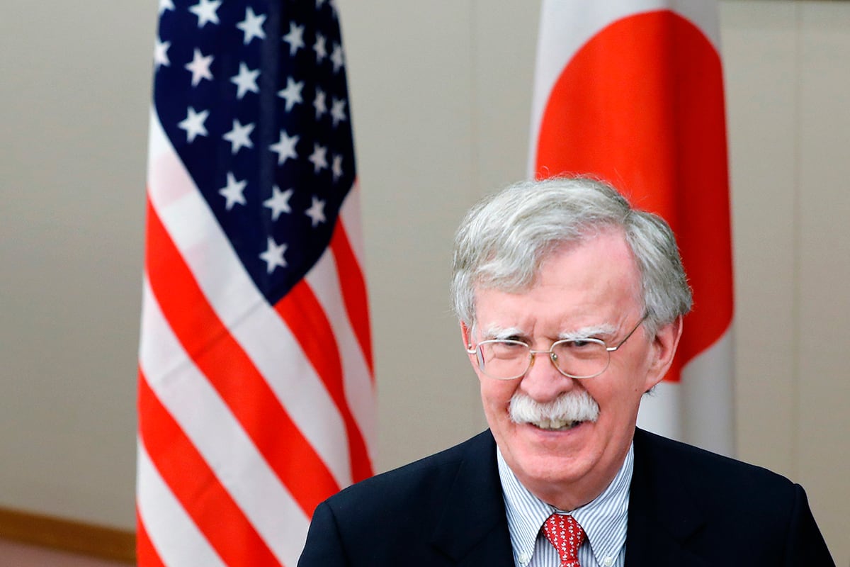 U.S. National Security Adviser John Bolton walks past U.S. and Japanese flags prior to a meeting with Japanese Foreign Minister Taro Kono in Tokyo Monday, July 22, 2019.