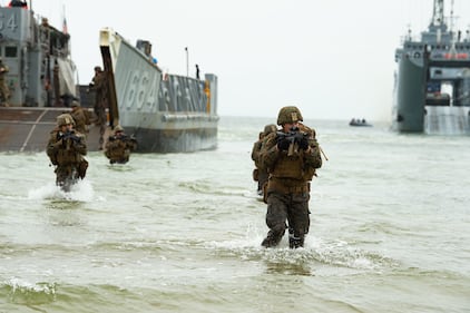 U.S. Marines wade ashore from a landing craft, utility on June 16, 2019, during an amphibious assault for exercise Baltic Operations (BALTOPS) 2019 in Klaipeda, Lithuania.