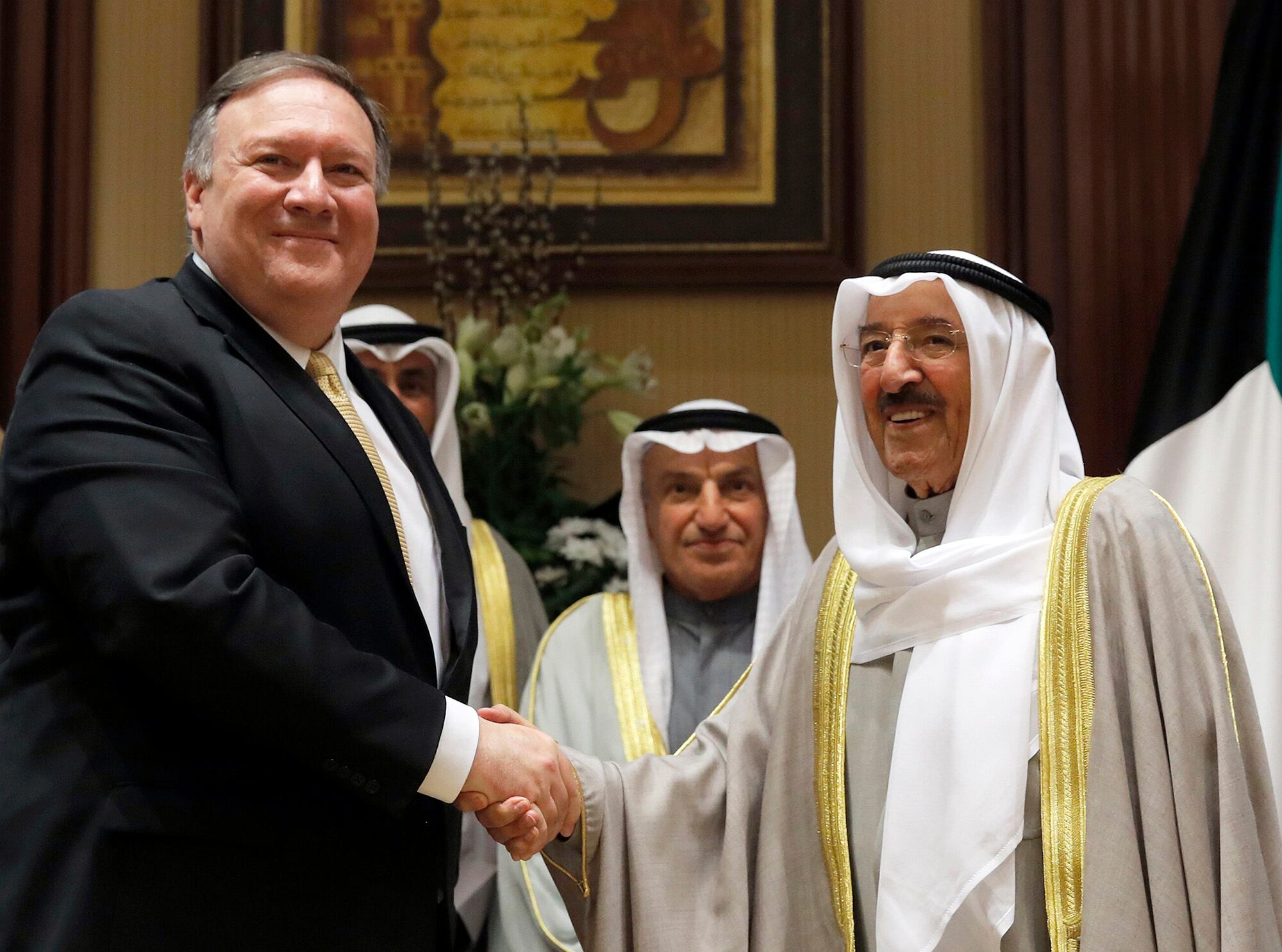 In this March 20, 2019, file photo, U.S. Secretary of State Mike Pompeo, left, shakes hands with Kuwait's Emir Sheikh Sabah Al-Ahmad Al- Jaber Al-Sabah, in Kuwait City, Kuwait.