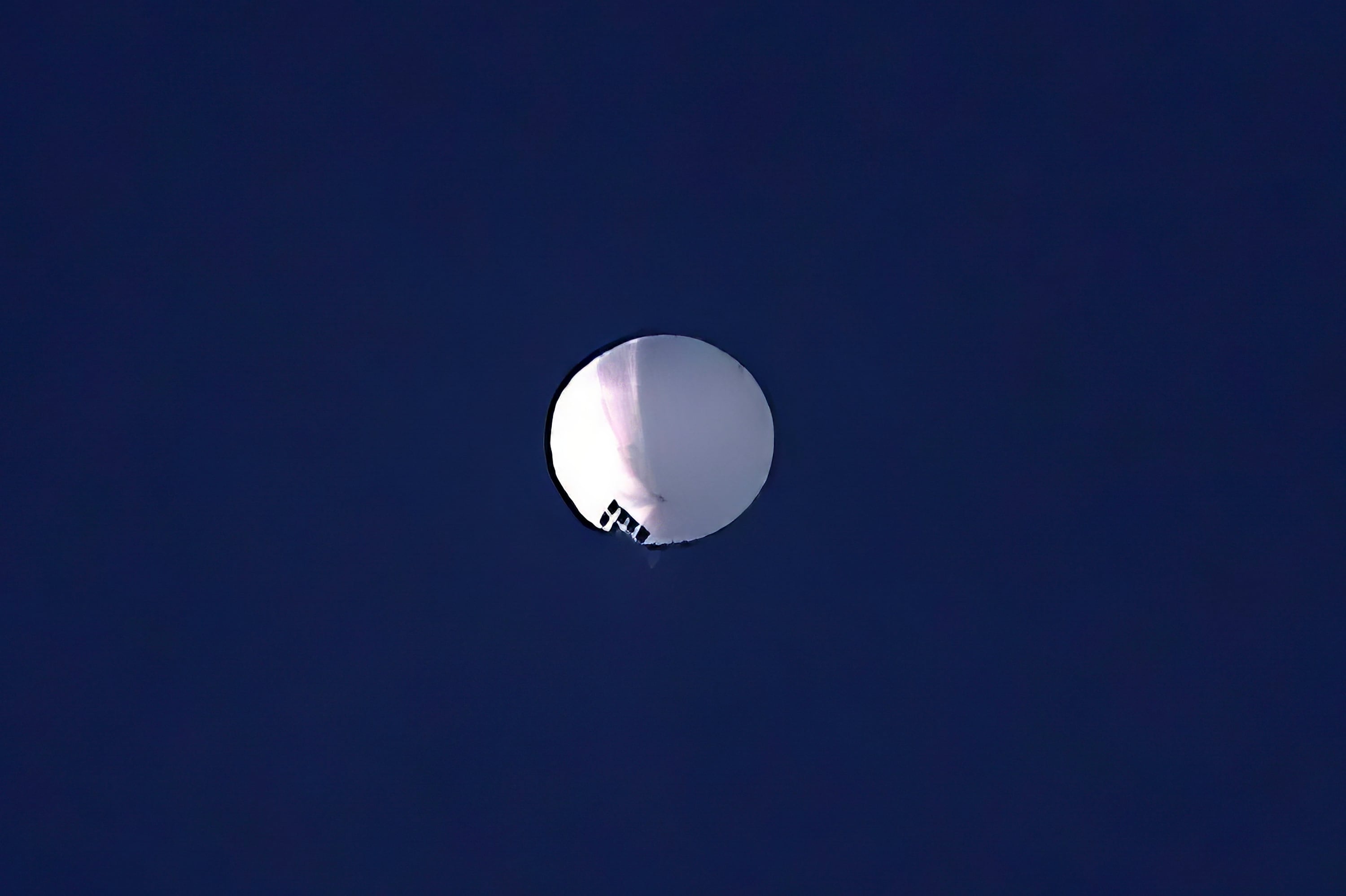 A high altitude balloon floats over Billings, Mont., on Wednesday, Feb. 1, 2023. The huge, high-altitude Chinese balloon sailed across the U.S. on Friday, drawing severe Pentagon accusations of spying and sending  excited or alarmed Americans outside with binoculars.