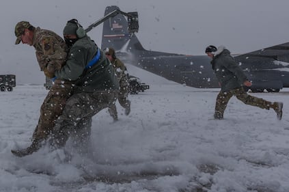 Hercules Airmen de-ice aircraft, re-ice each other