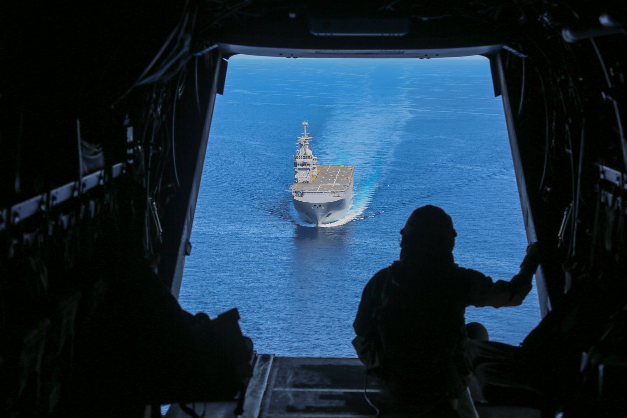 Cpl. Tyler Truong, MV-22B Osprey crew chief, observes the French Navy amphibious assault ship Mistral on June 24, 2020, in the Mediterranean Sea.