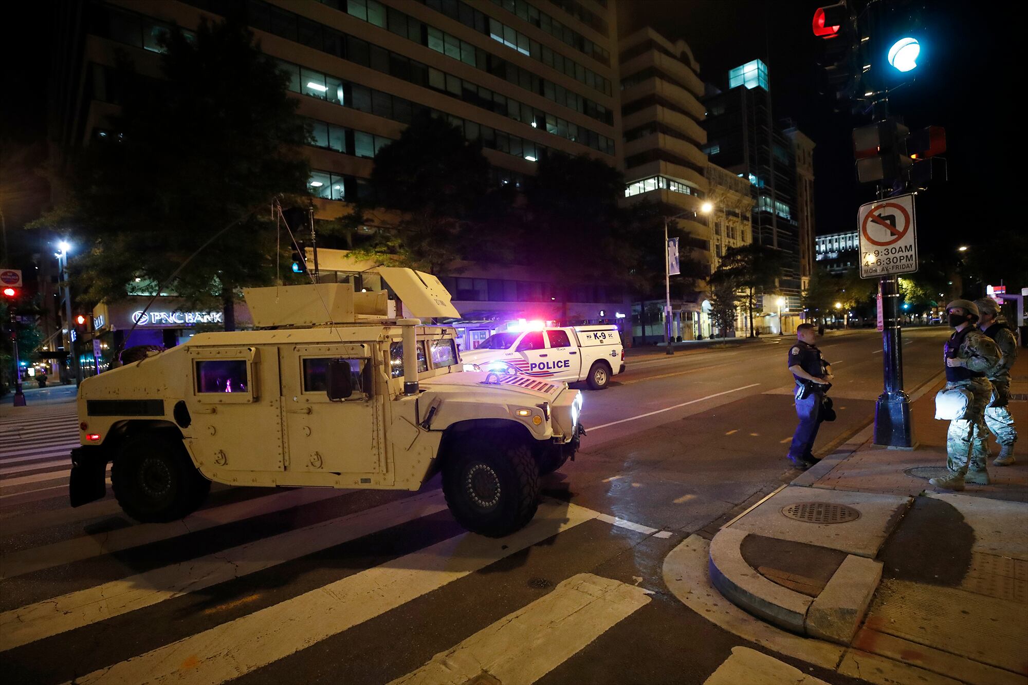 A military Humvee blocks an intersection along K Street in downtown Washington as demonstrators protest the death of George Floyd, Monday, June 1, 2020, in Washington.