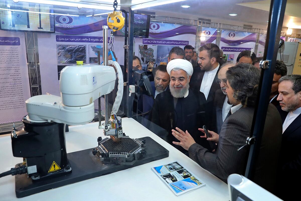 President Hassan Rouhani listens to explanations on new nuclear achievements at a ceremony to mark "National Nuclear Day," in Tehran, Iran.