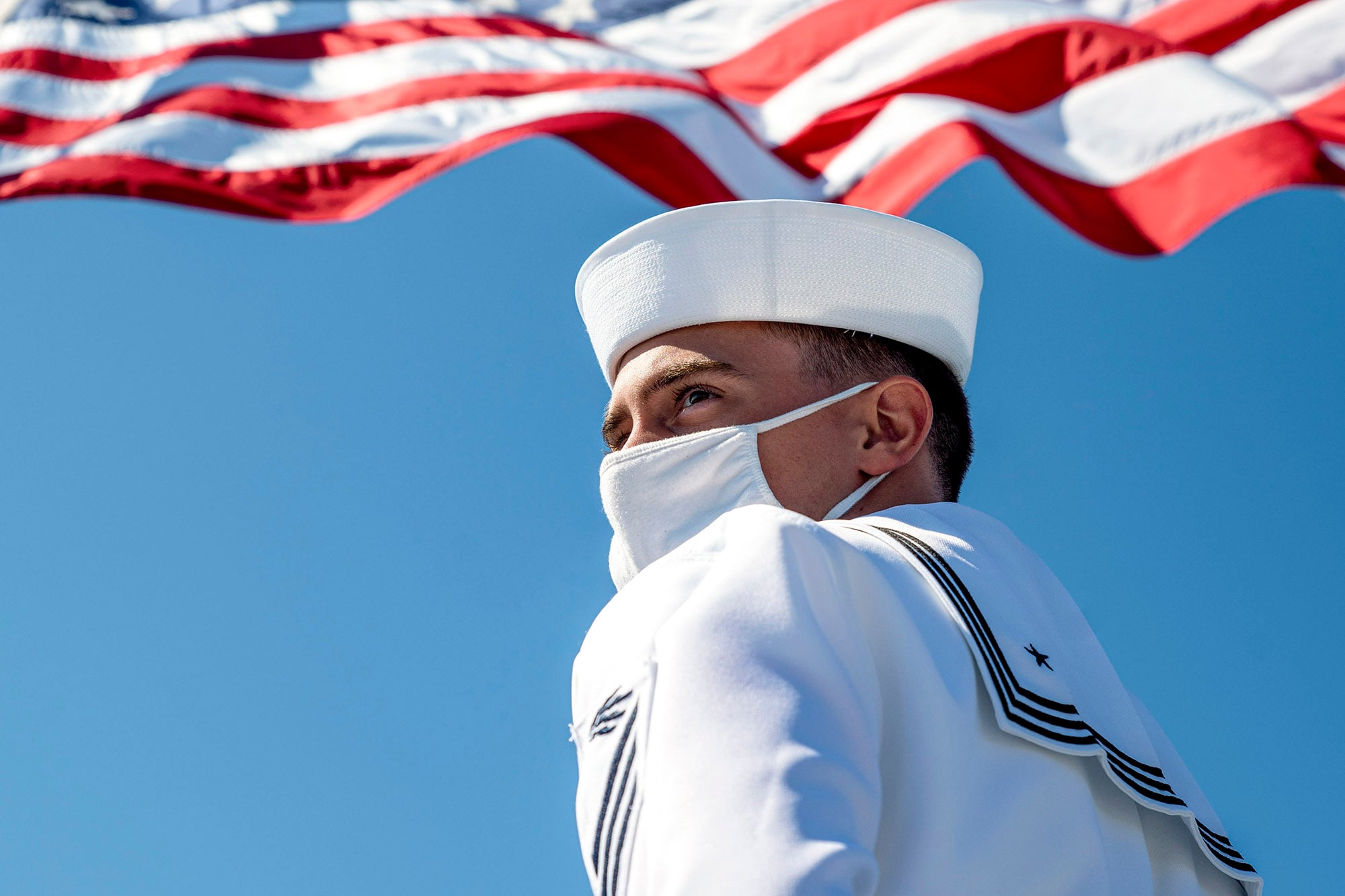 Information Systems Technician Seaman Russell Brown prepares to lower the American flag aboard the Blue Ridge-class command and control ship USS Mount Whitney (LCC 20) in Gaeta, Italy, July, 20, 2020.