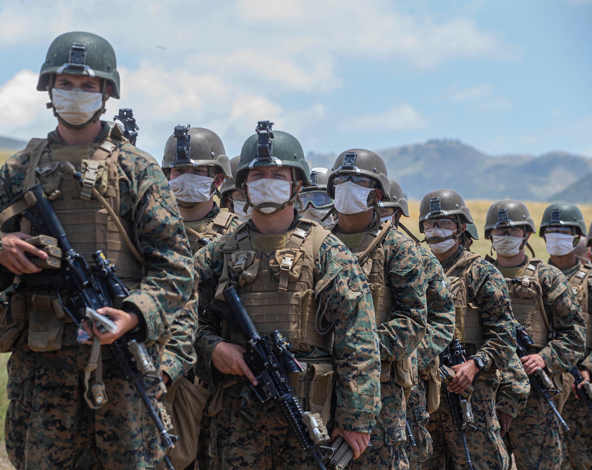 Marines with Alpha Company, Infantry Training Battalion, School of Infantry - West, wait to be lined out after live-fire training on Range 210F on Marine Corps Base Camp Pendleton, Calif.