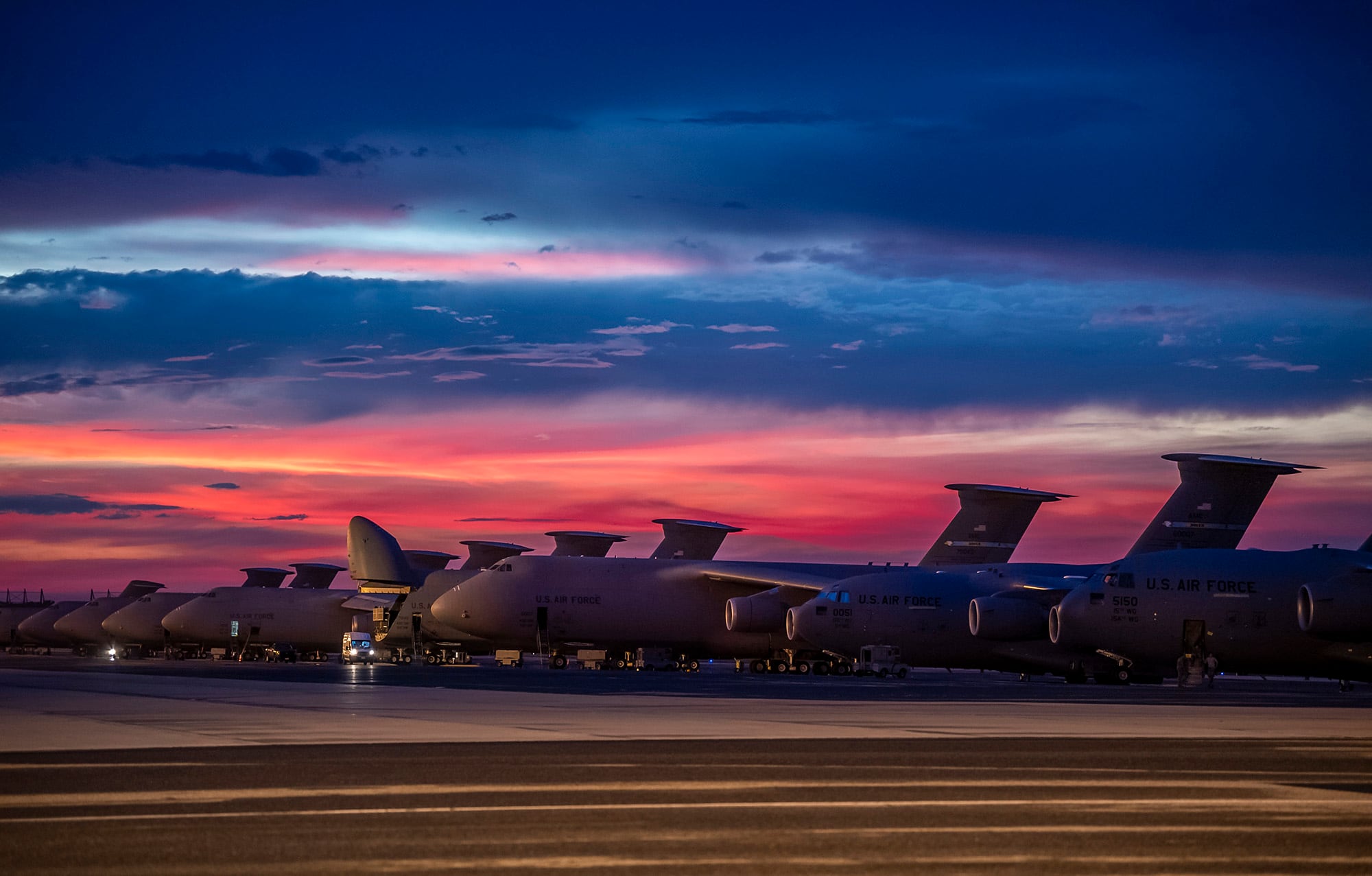 The sun sets over Dover Air Force Base, Del., as airmen work on the flightline Aug. 12, 2020.