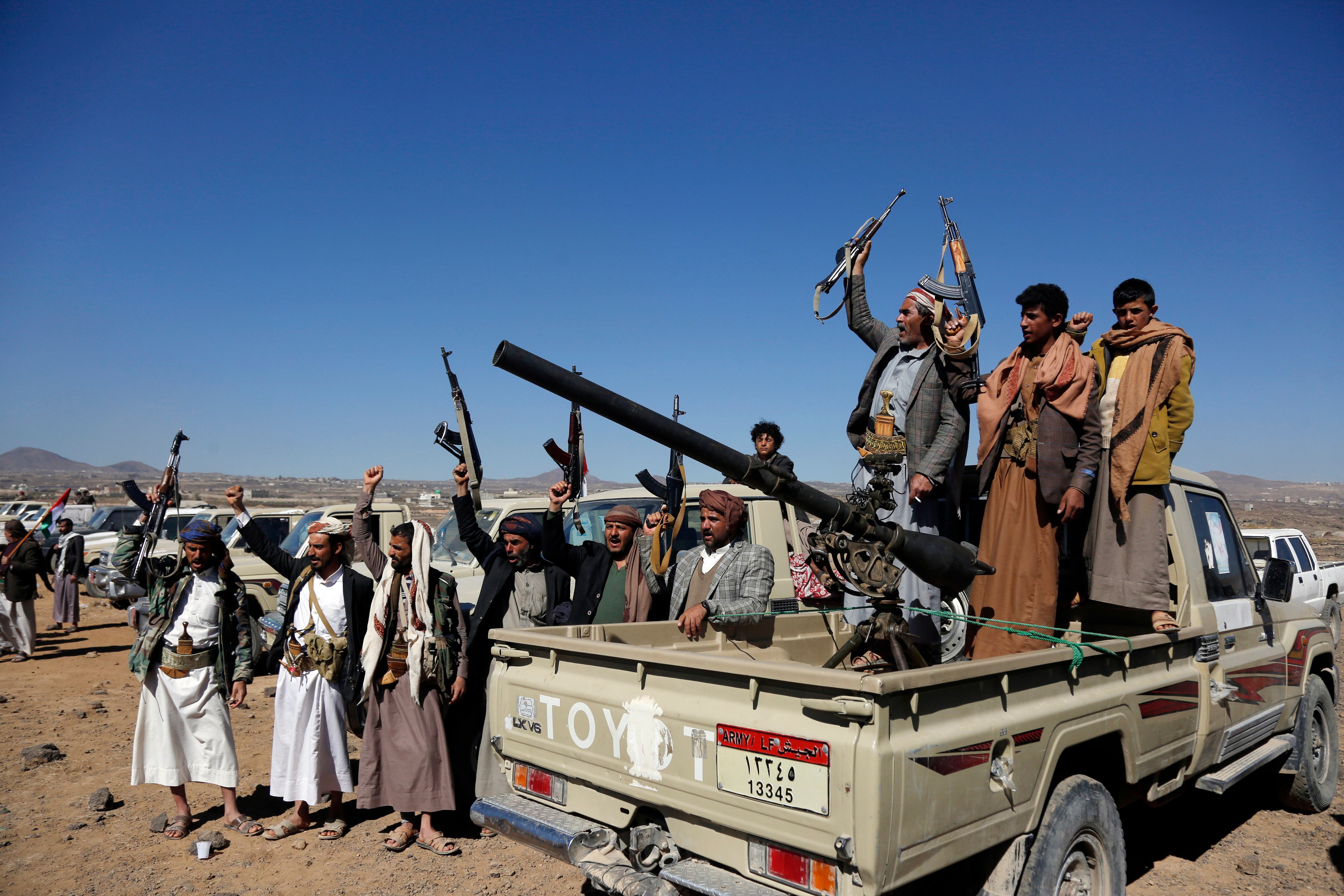 Houthi fighters and tribesmen stage a rally against the U.S. and the U.K. strikes on Houthi-run military sites near Sanaa, Yemen, on Sunday, Jan. 14, 2024.