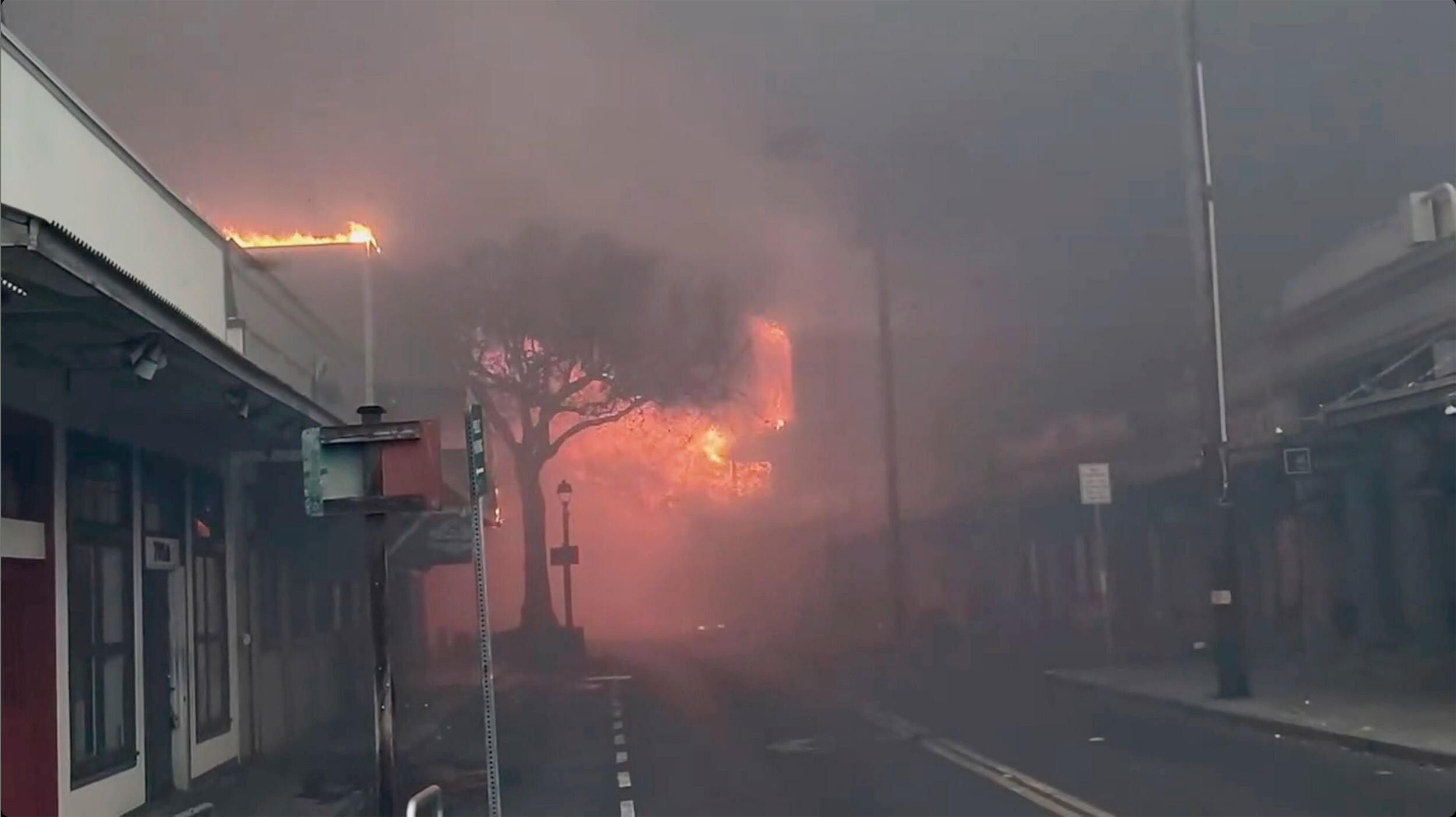 Smoke and flames fill the air from raging wildfires on Front Street in downtown Lahaina, Maui on Tuesday, Aug. 8, 2023.