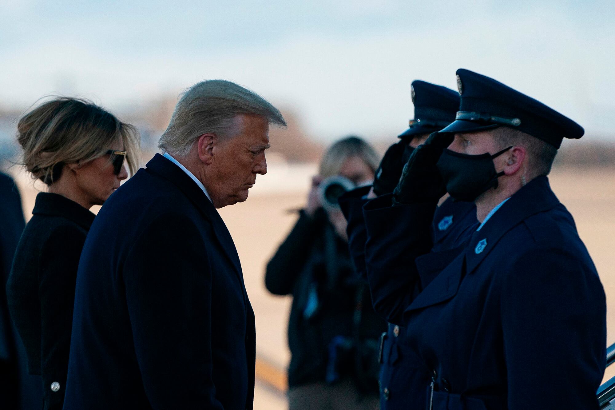 Outgoing President Donald Trump and first lady Melania Trump step out of Marine One at Joint Base Andrews in Maryland on Jan. 20, 2021.