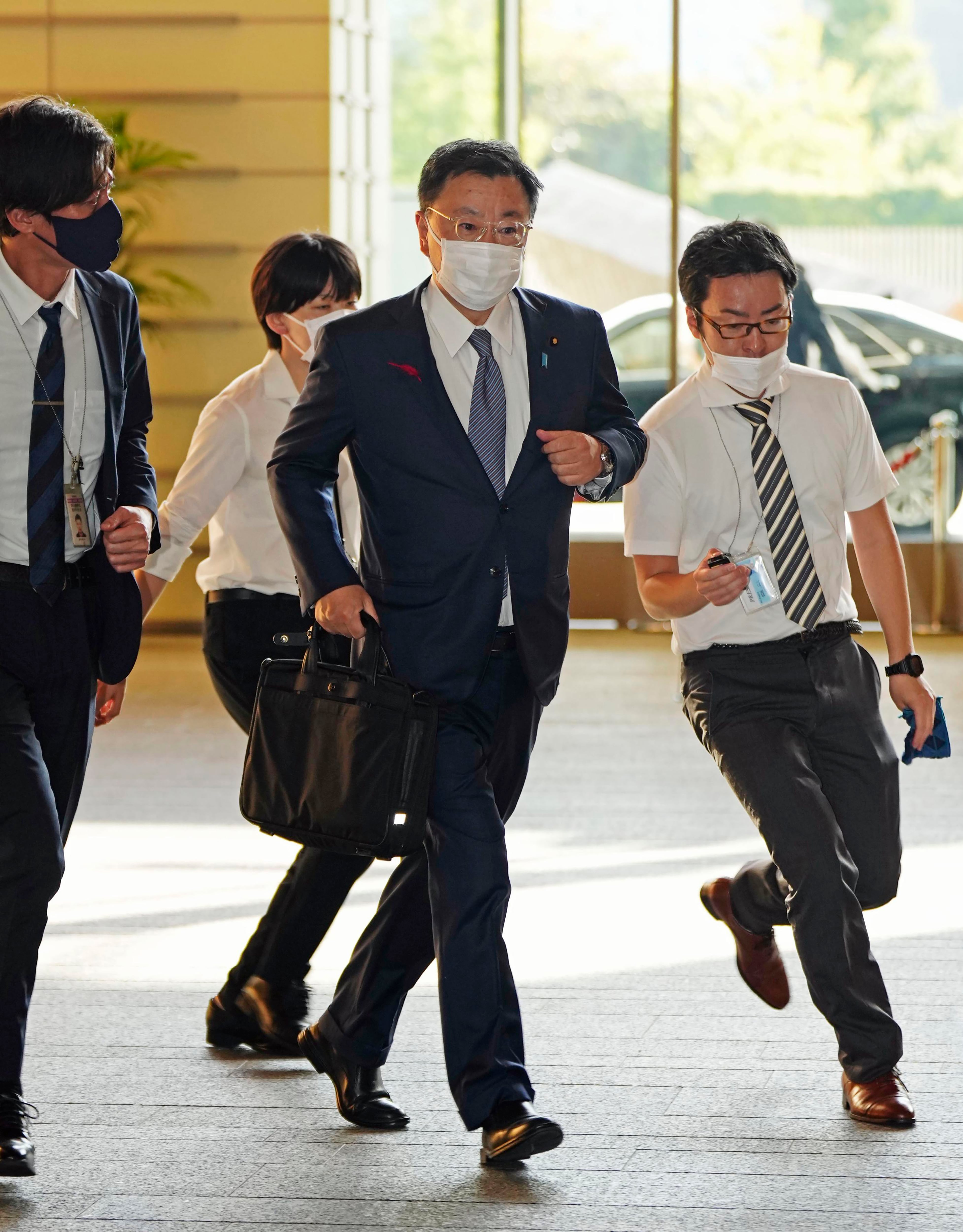 Japan's Chief Cabinet Secretary Hirokazu Matsuno, center, arrives at the prime minister's office in Tokyo Tuesday, Oct. 4, 2022.