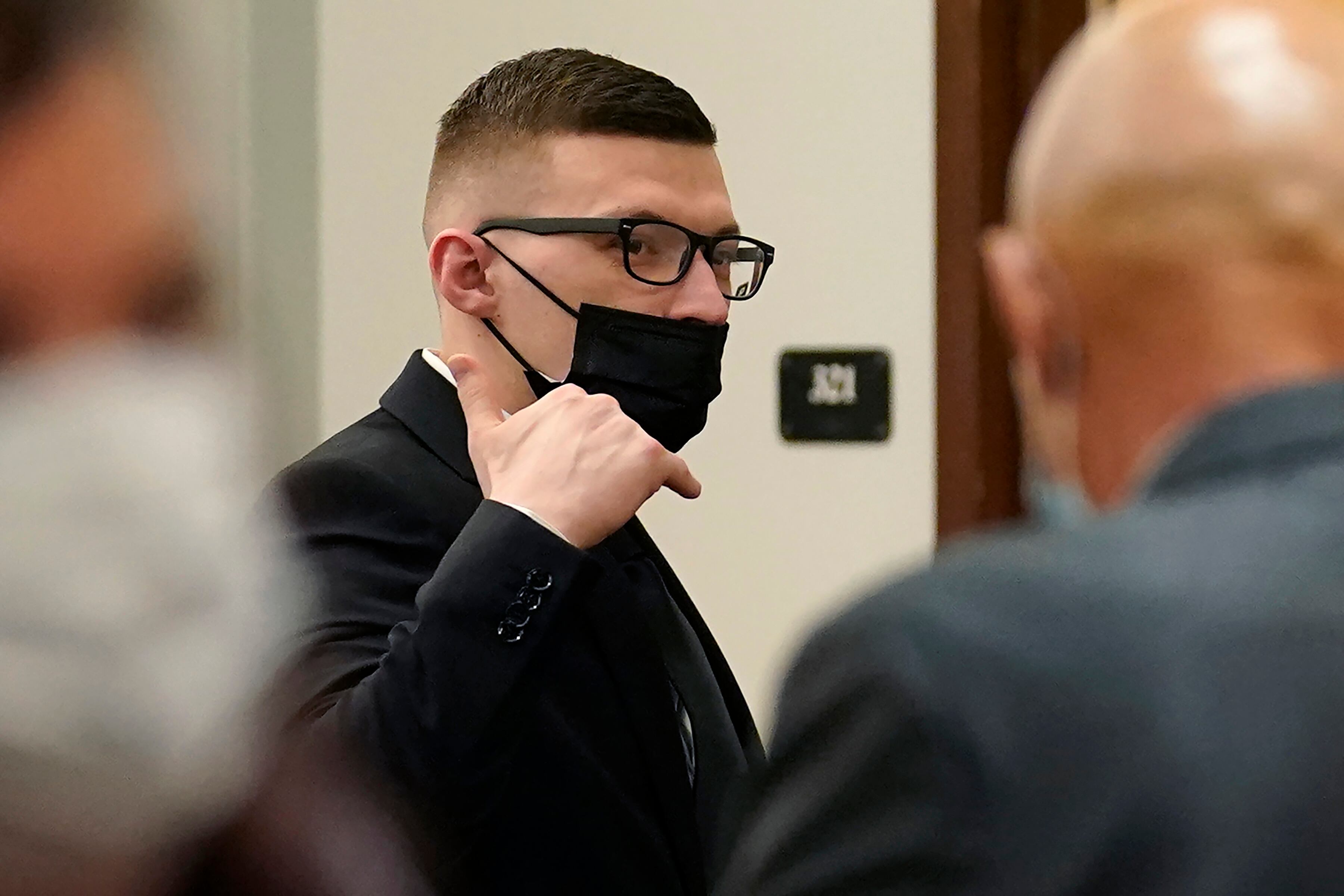 Volodymyr Zhukovskyy raises his hand while departing a courtroom at Coos County Superior Court in Lancaster, N.H., Tuesday, July 26, 2022.