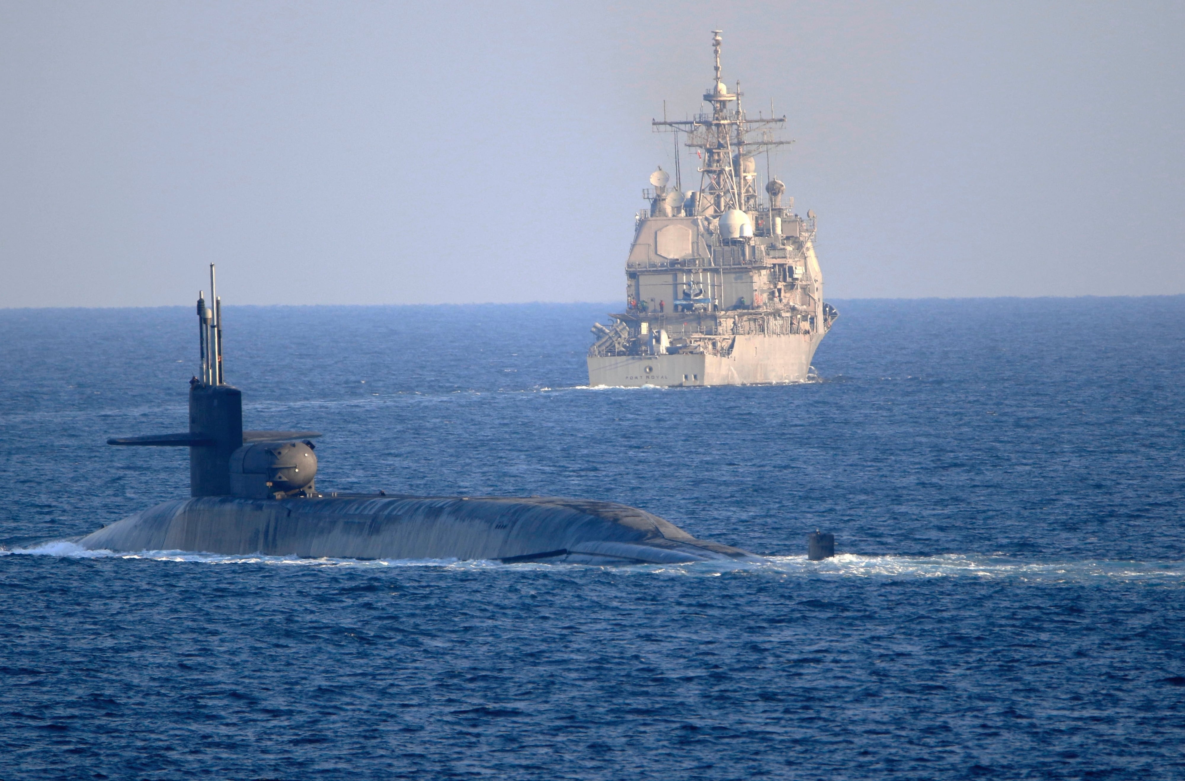 The guided-missile submarine USS Georgia, front, with the guided-missile cruiser USS Port Royal, transits the Strait of Hormuz in the Persian Gulf on Dec. 21, 2020.