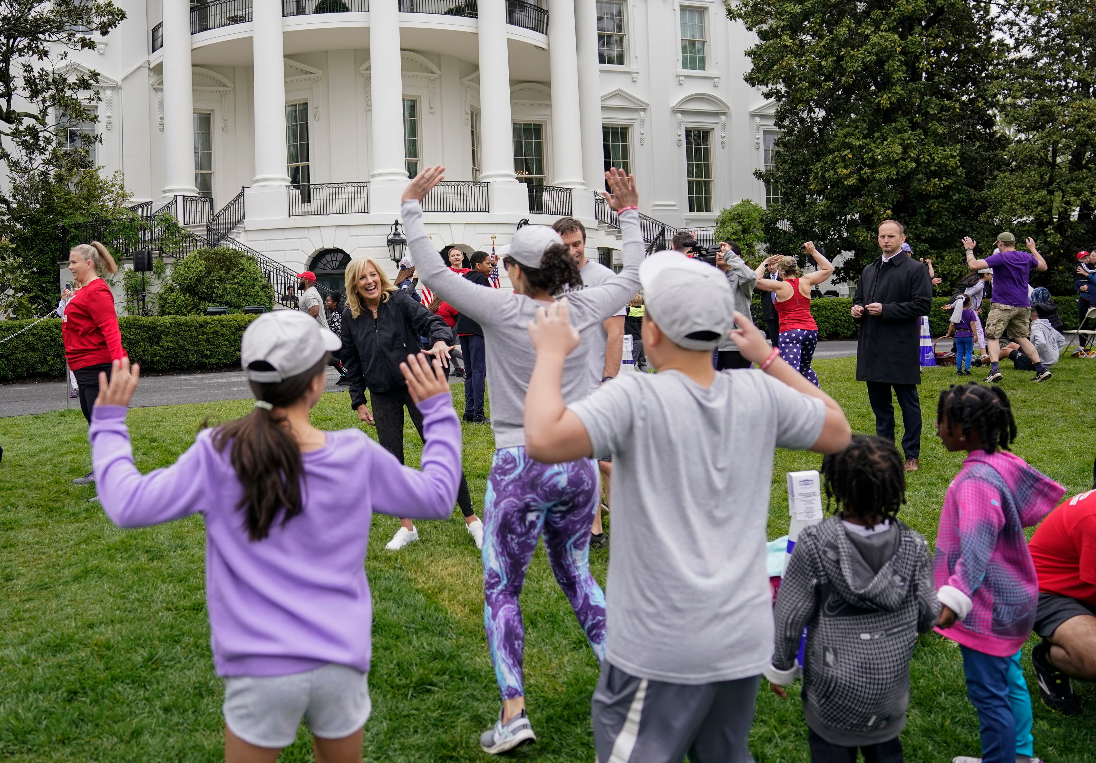 First lady Jill Biden walks though kids and families as they workout during the Joining Forces Military Kids Workout on the South Lawn of the White House in Washington, Saturday, April 29, 2023.